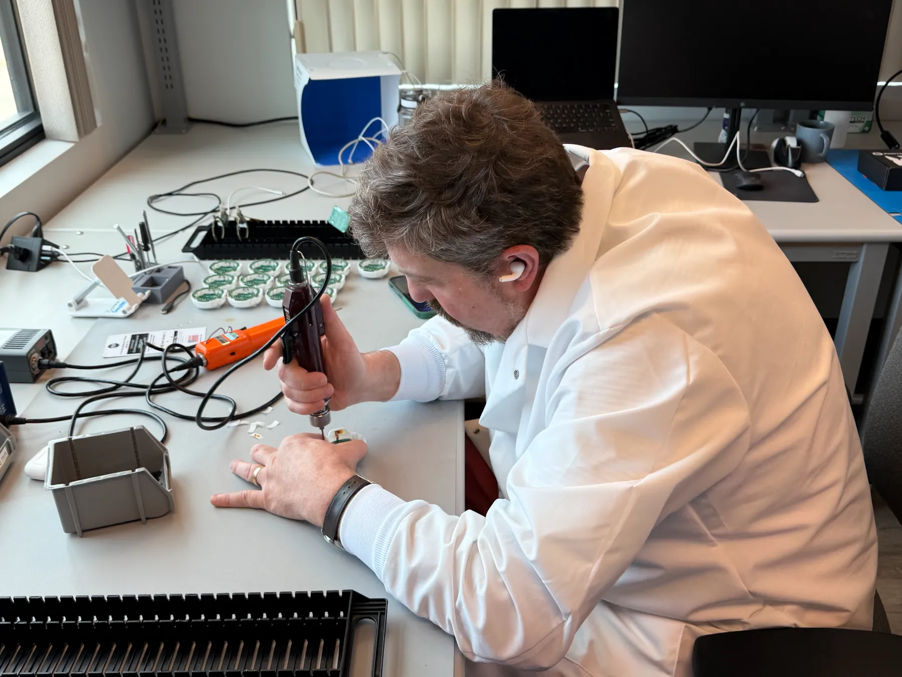 An AQOIR engineer assembling sensors at the lab bench